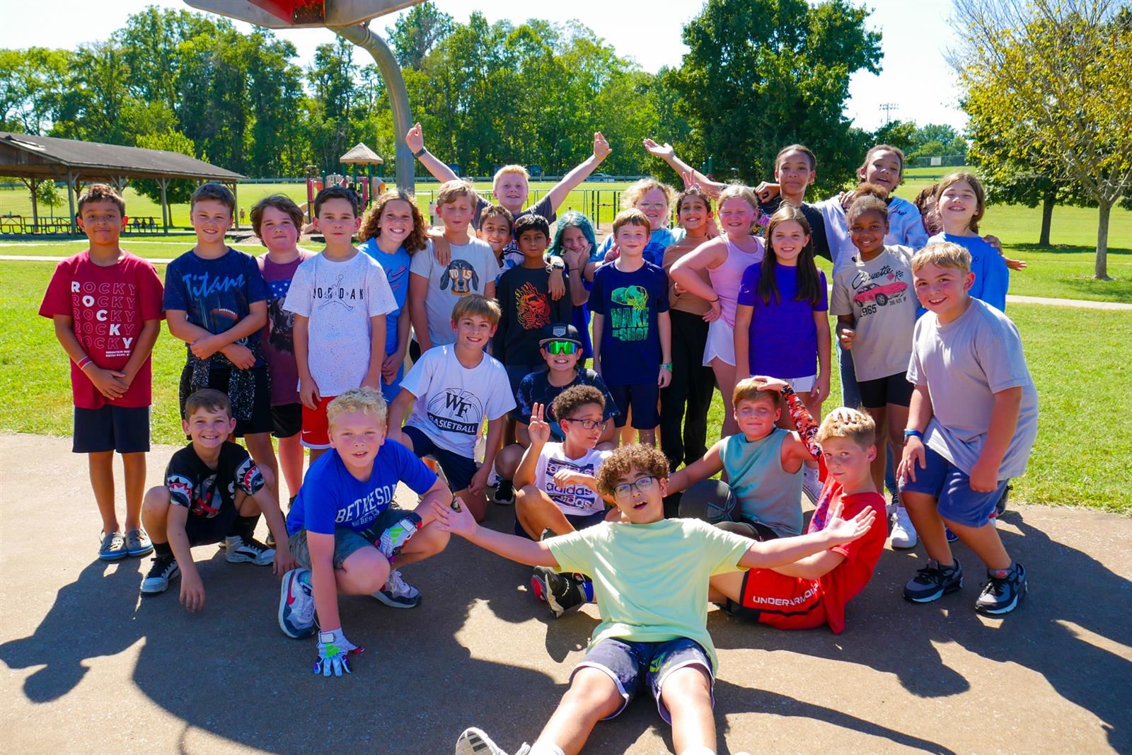 Students giving a thumbs up at the Fun Run outside.